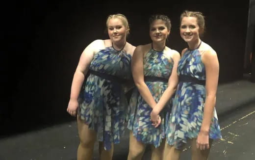 a group of women in dresses