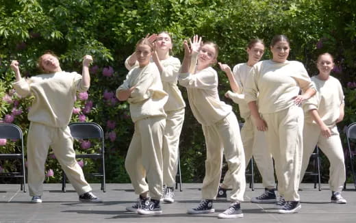 a group of people in white outfits