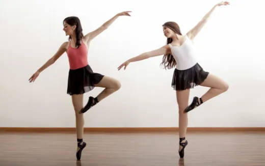 two women dancing on a stage