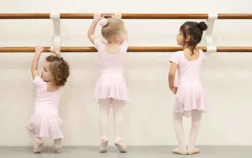 a group of girls in white dresses