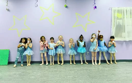 a group of girls in blue dresses
