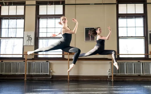 two women dancing on a stage