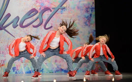 a group of people dancing on a stage