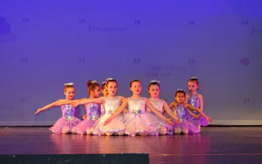 a group of girls in dresses