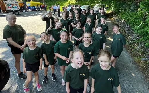 a group of children in green shirts
