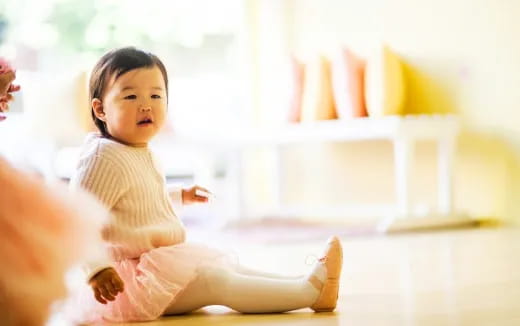 a baby sitting on the floor