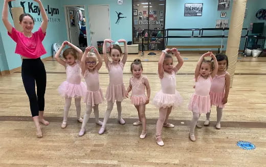a person and a group of girls in a room