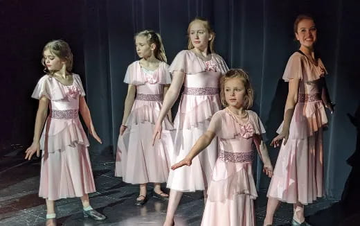 a group of girls in dresses