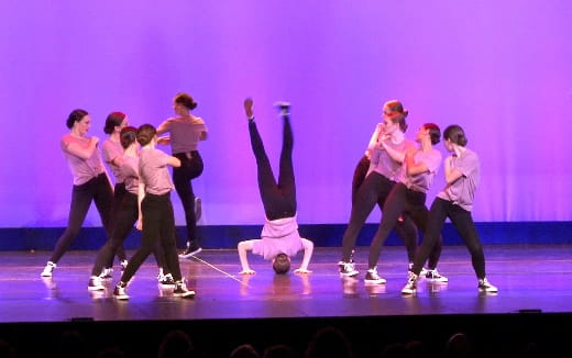 a group of people dancing on a stage
