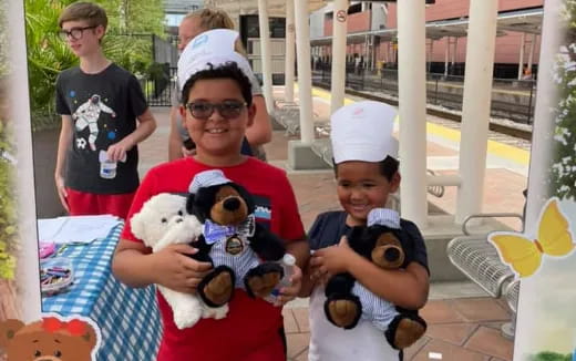 a group of people holding stuffed animals