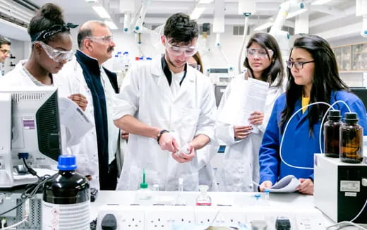 a group of people in lab coats
