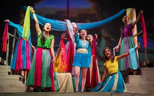a group of women in colorful dresses