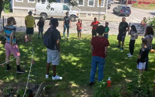 a group of people playing with sticks