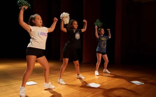 a group of girls dancing on a stage