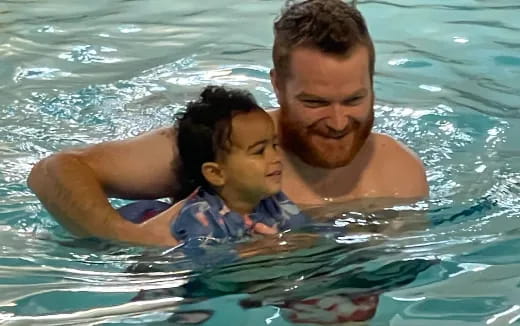 a person and a child in a pool
