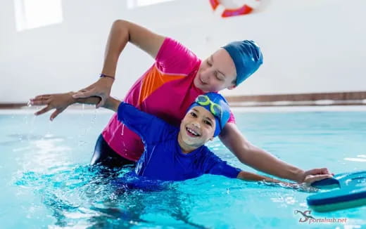 a couple of kids in a pool