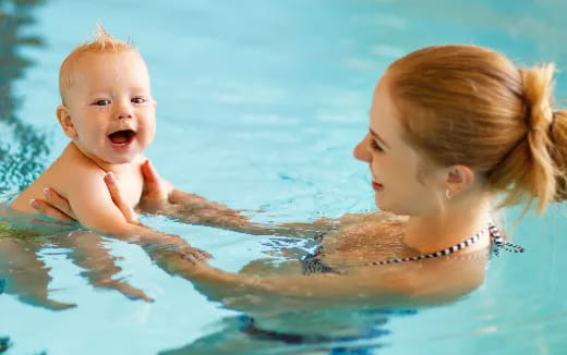 a person and a baby in the water
