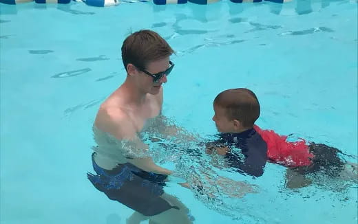 a person and a boy in a pool