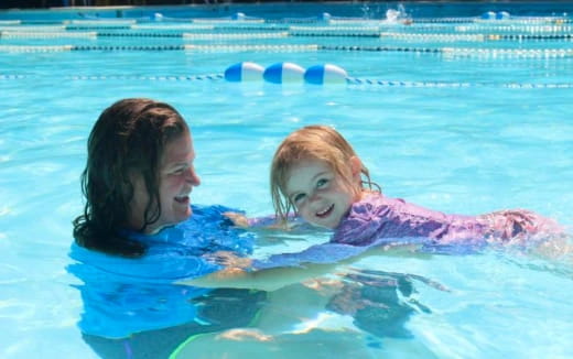 a person and a child in a pool