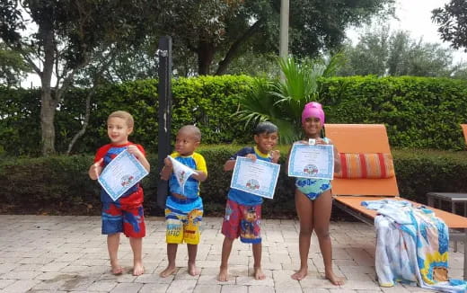 a group of children holding signs