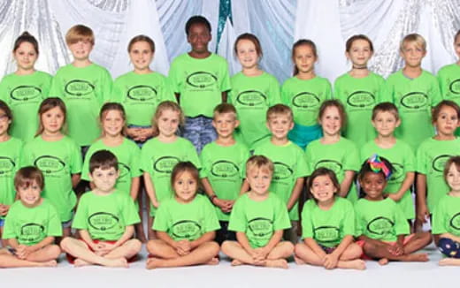 a group of people wearing green shirts