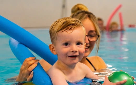 a person and a child in a pool