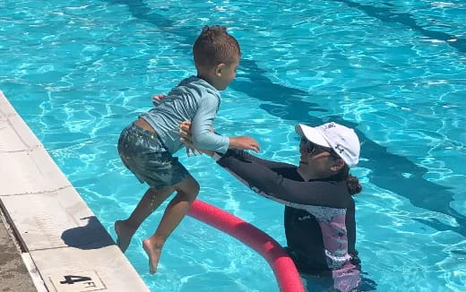 a man and a boy in a pool
