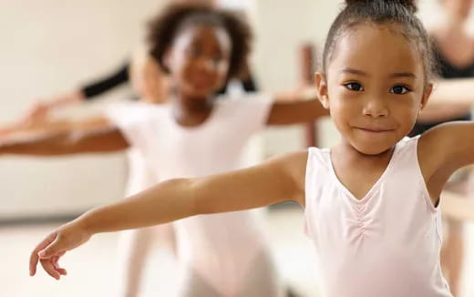 a young girl with her arms out