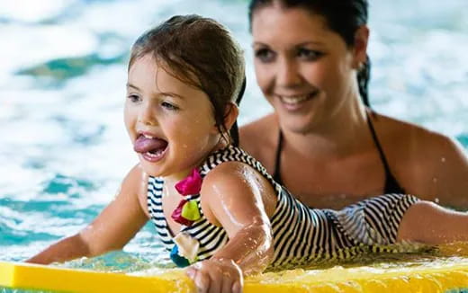 a person and a child in a pool