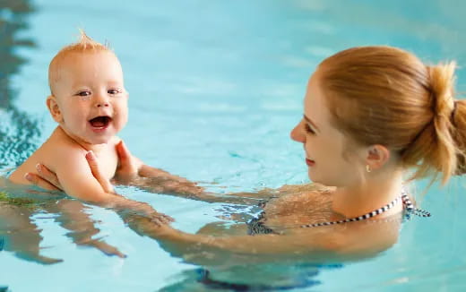a person and a baby in the water