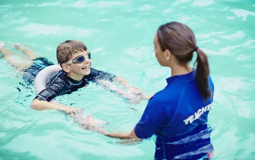 a person and a girl in a pool