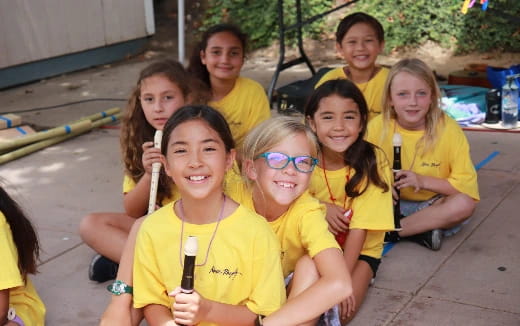 a group of children wearing yellow shirts