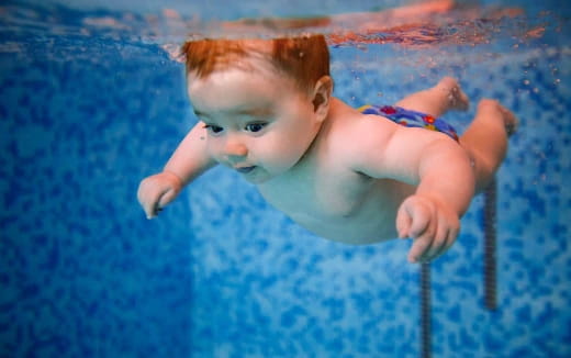 a baby in a pool