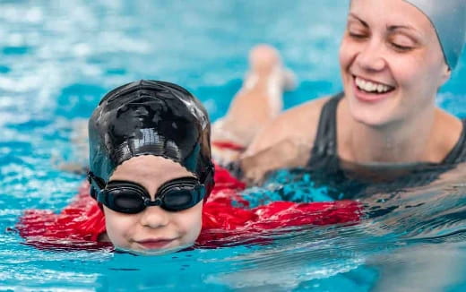 a person and a boy in a pool