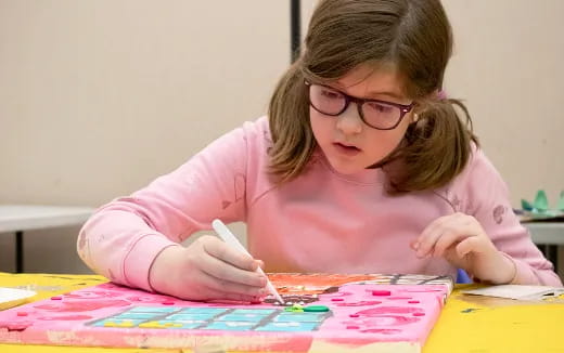 a girl painting on a table