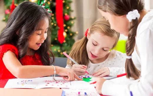 a group of children writing on paper