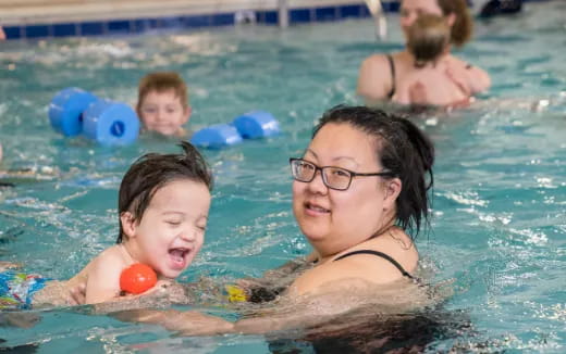 a person and a child in a pool