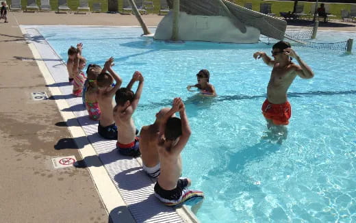 a group of children in a pool