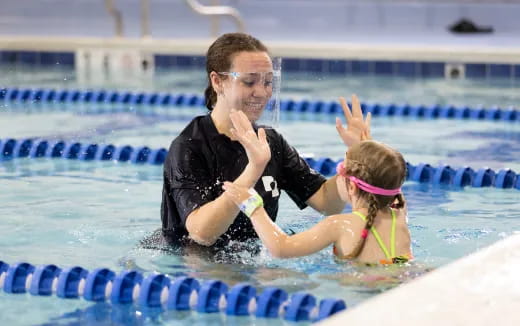 a person and a child in a pool