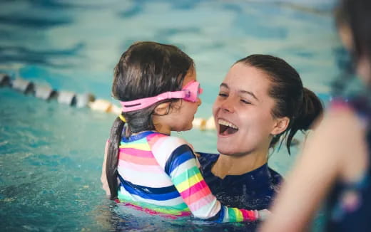 a person and a child in a pool