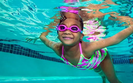 a person in a pool wearing goggles