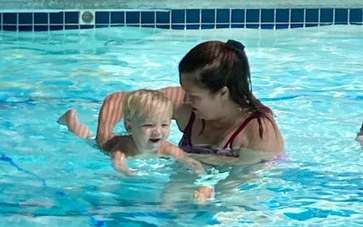 a man and a child in a pool