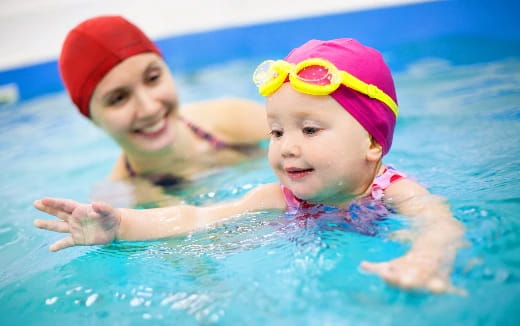 a couple of kids in a pool