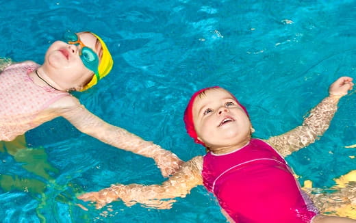 a couple of kids in a pool