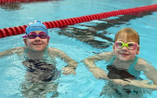 a couple of kids in a pool