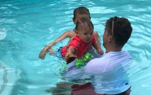 a person and two children in a pool
