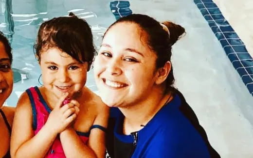 a woman and a girl in a swimming pool