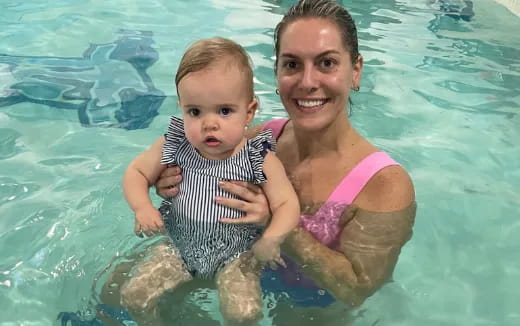 a person and a baby in a pool