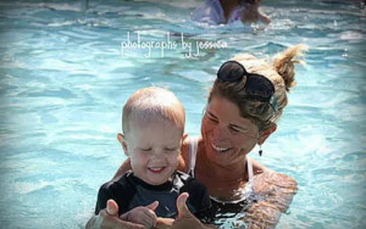 a man and a baby in a pool