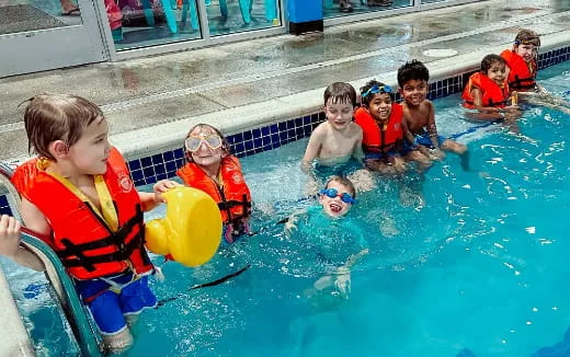 a group of kids in a pool
